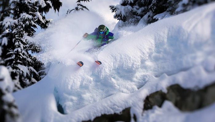 Skier skiing through powder